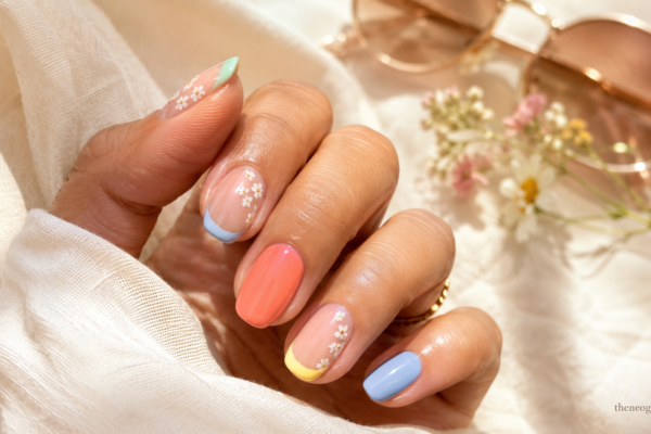 Cute summer nails with pastel French tips, tiny flowers, coral accents, and a glossy feminine finish