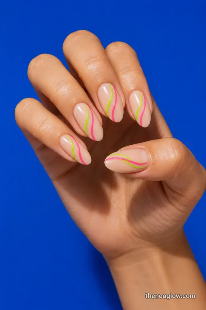 Medium almond nails with parallel lime and hot-pink waves over a sheer beige base.