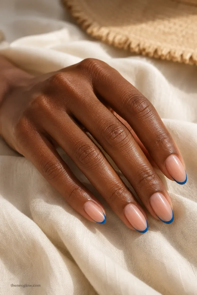 Ocean-blue French tips on medium almond nails