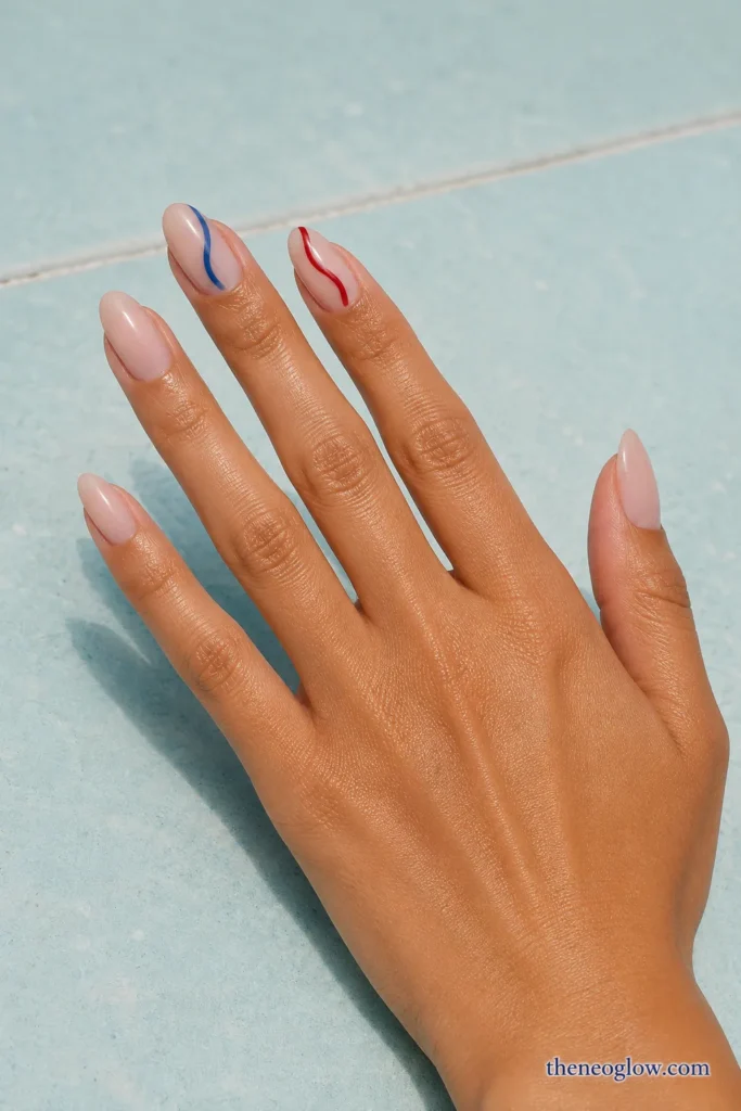 Medium almond sheer nails with separate flowing cherry-red and cobalt ribbon-wave accents.