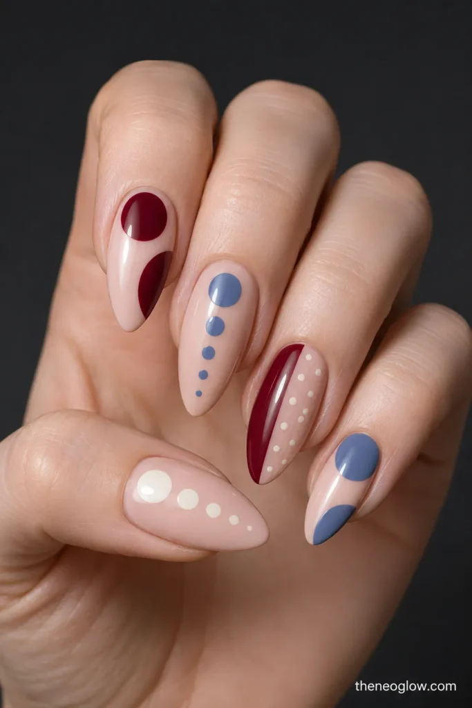 Glossy almond nails with oversized cropped circles, graduated bubble dots, and a curved color block beside a dotted field.