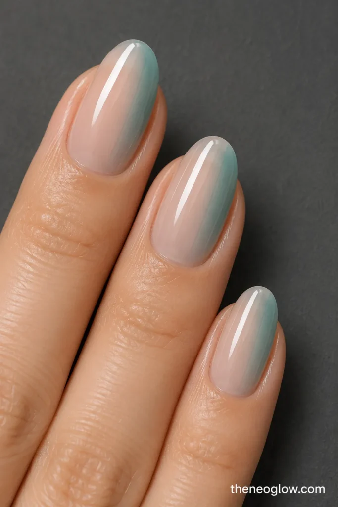 Three oval nails with pale teal color fading from one sidewall into clear centers.