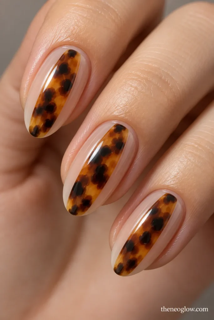 Medium oval nails with narrow vertical tortoiseshell panels floating between sheer side borders.