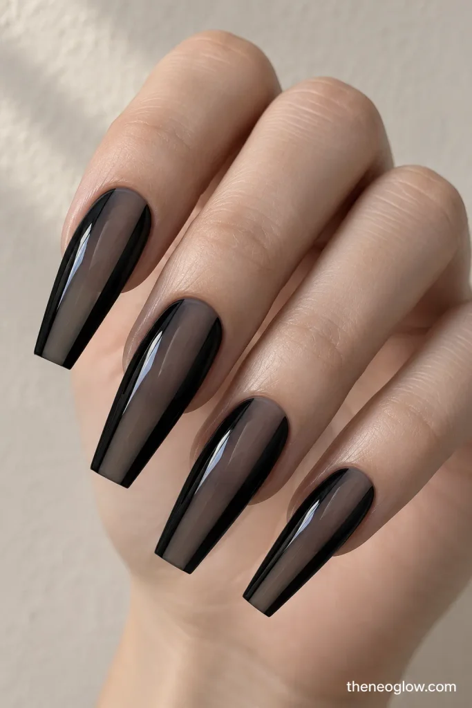 Long coffin nails with translucent charcoal centers and opaque black sidewalls.