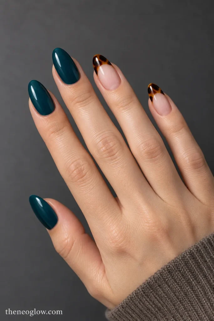 Deep teal solid nails paired with glossy tortoiseshell French-tip accents in the same shape.
