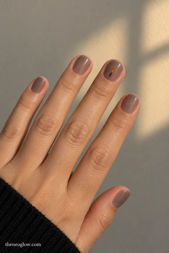 Short smoky sheer nails with one tiny muted-orange flame and black wick accent. simple Halloween nails for short nails