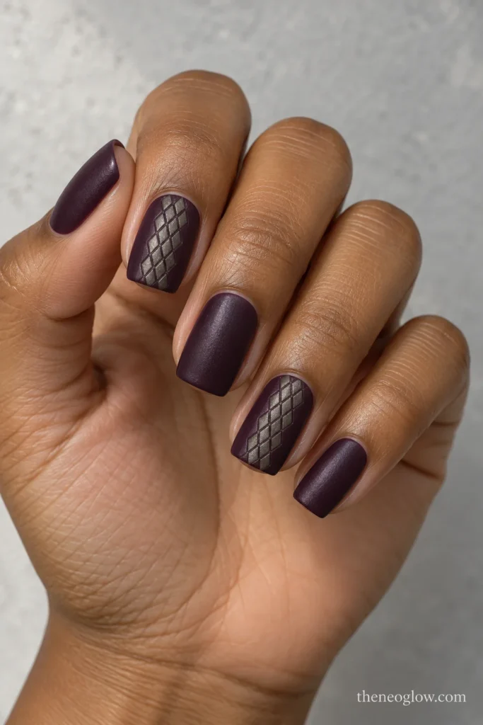 Aubergine satin square nails with compact interlocking pewter lozenges across the centers of two accent nails.