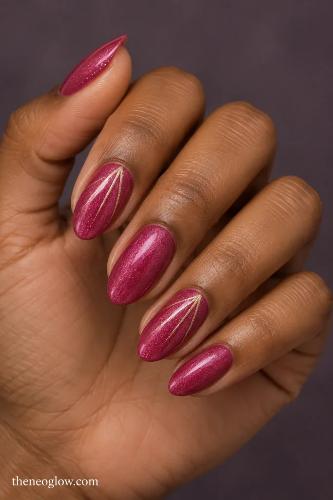 Medium berry-pink shimmer almond nails with three fine champagne rays near the tips of index and ring fingers. pink christmas nails