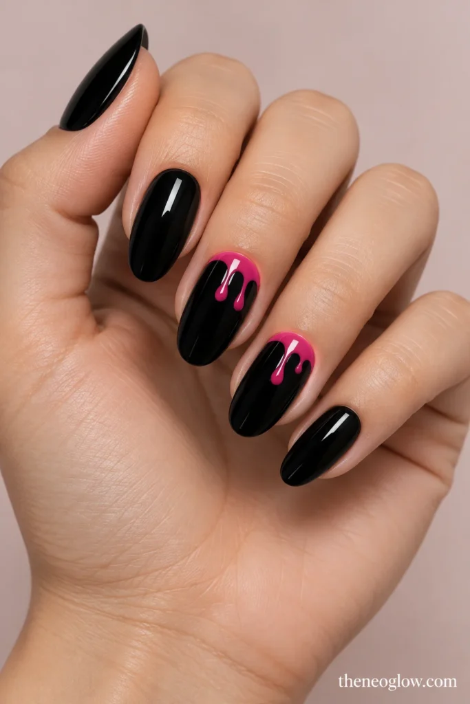 Glossy black nails with two fuchsia-edged drip accent nails.