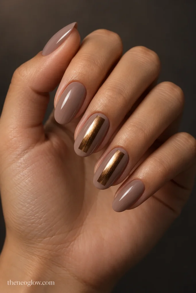 Medium oval taupe nails with narrow softly reflective bronze center panels.