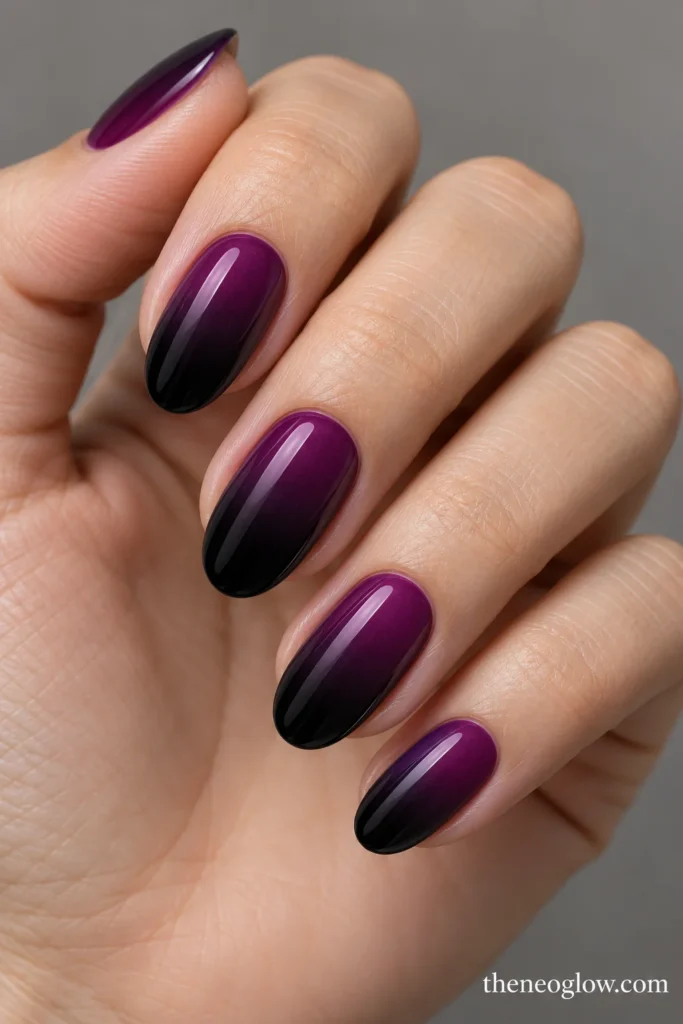 Medium oval nails fading from violet plum at the cuticles to dark aubergine tips.