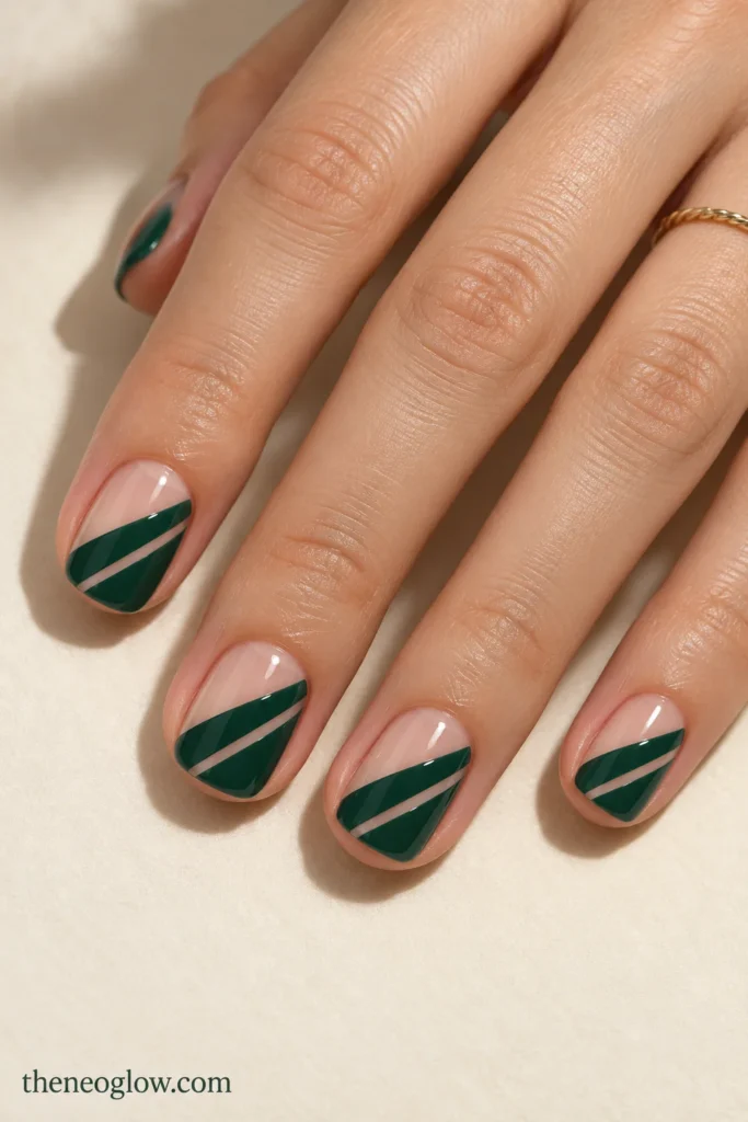 Short squoval nails with glossy evergreen diagonal fields interrupted by narrow transparent negative-space slashes.