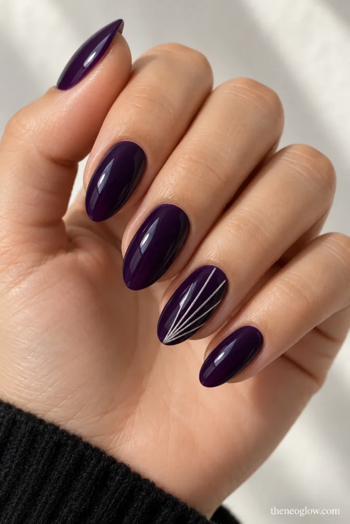 Glossy ink-purple almond nails with five fine silver rays fanning from ring-finger corners.
