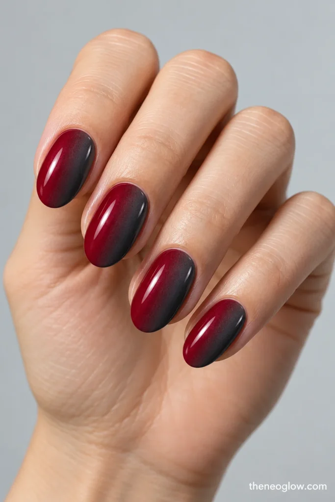 Oval nails with a glossy sideways gradient from merlot wine red to charcoal gray.