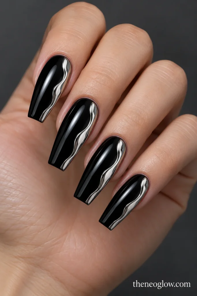 Glossy black coffin nails with irregular molten-silver shapes along one side of each nail.