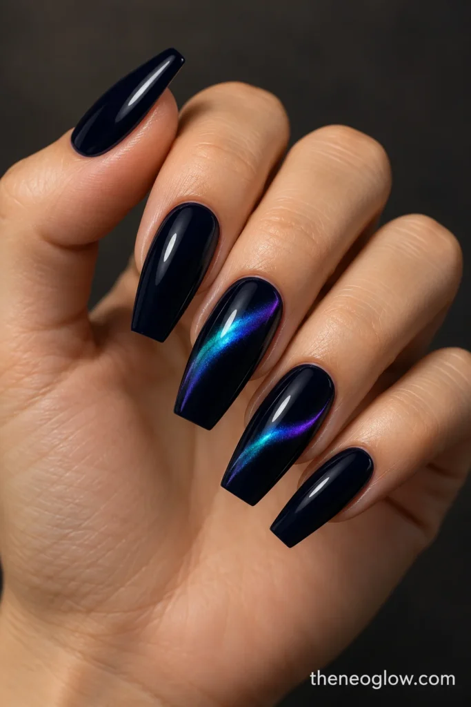 Near-black blue coffin nails with narrow teal-to-violet aurora arcs on two accent fingers.