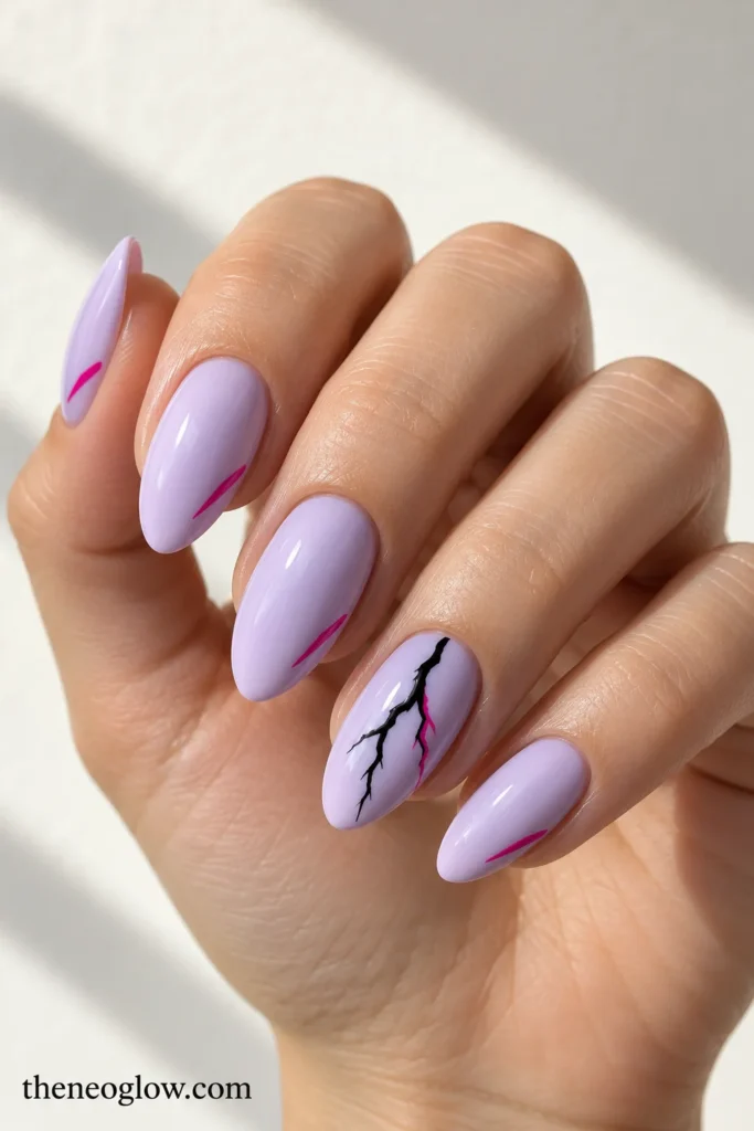 Pale lilac almond acrylics with a black-and-fuchsia lightning accent and small side strokes.