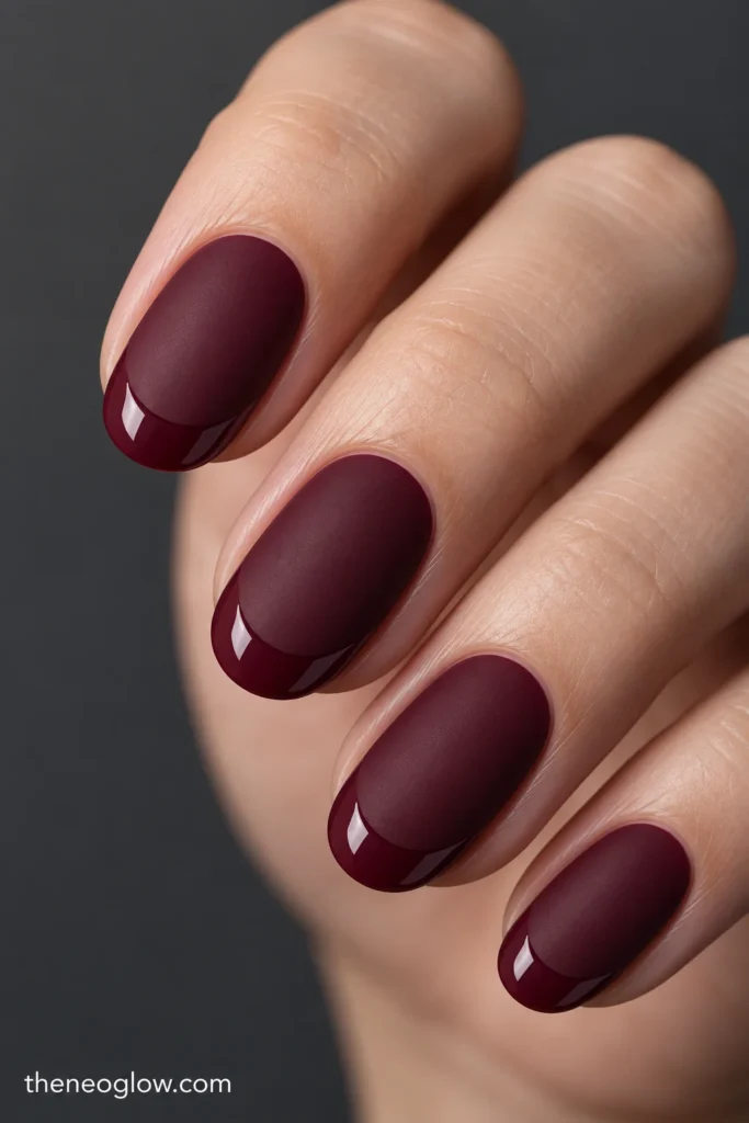 Medium oval mulled-wine nails with matte surfaces and narrow glossy tip arcs.