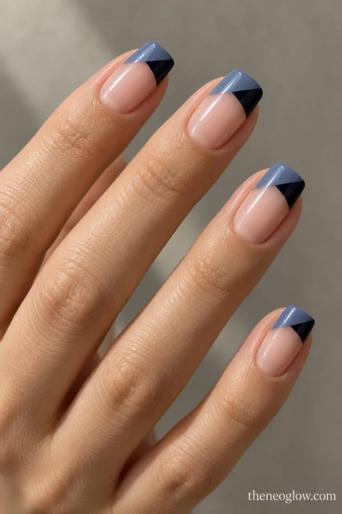 Medium soft-square nails with diagonal slate-blue and navy split French tips.