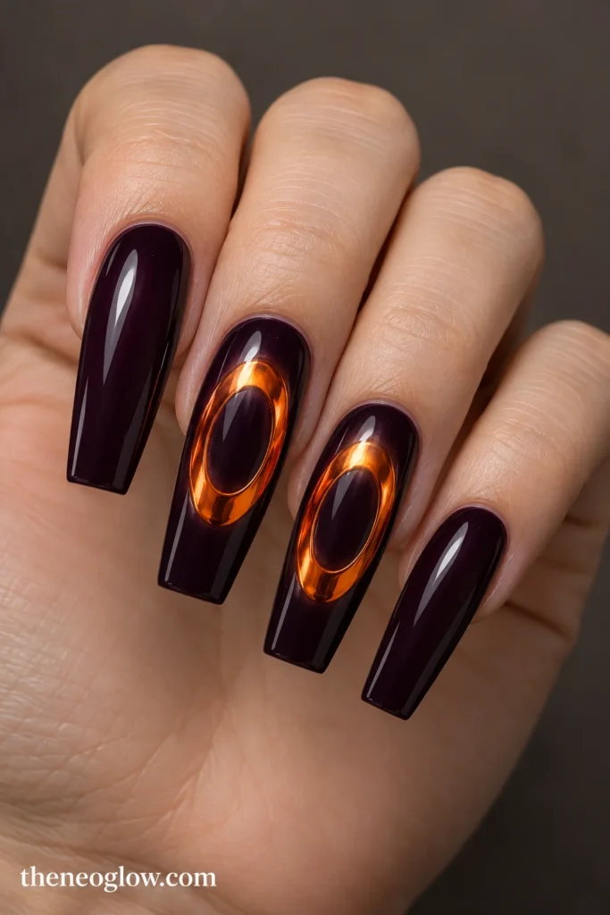 Deep plum coffin acrylics with flat molten-orange chrome oval rings on the middle and ring nails.
