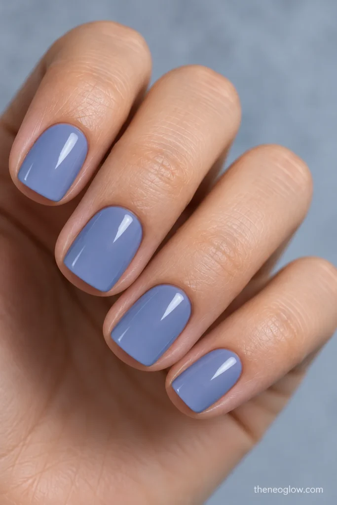 Very short soft-square nails painted glossy muted periwinkle blue-violet.