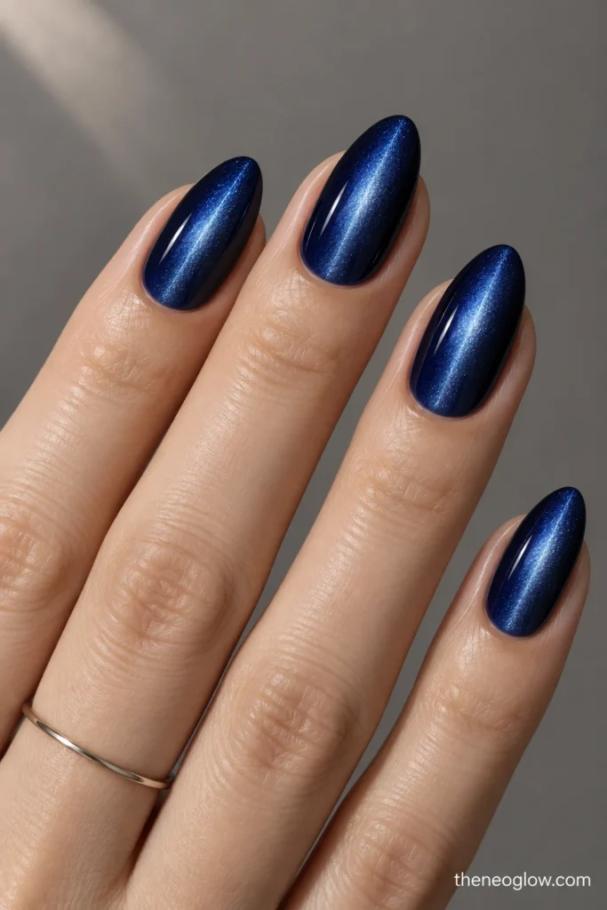 Medium almond sapphire nails with a narrow cobalt-silver magnetic beam through the center