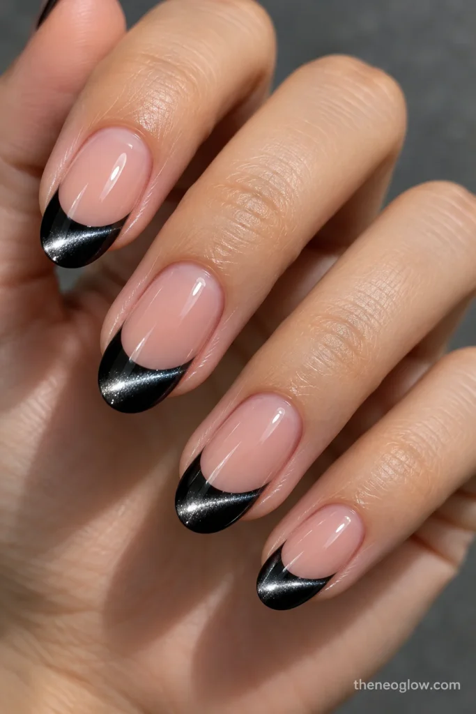 Oval nails with black cat-eye French tips and a single angled silver magnetic beam on each tip.
