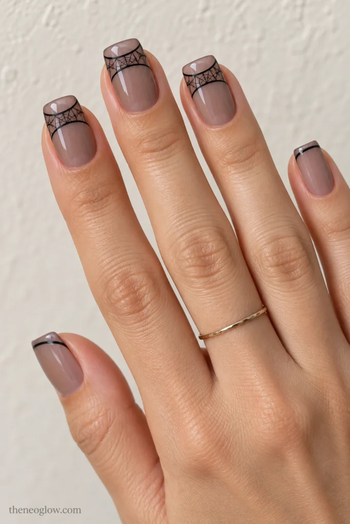 Medium squoval taupe nails with two black smile lines forming a transparent web-filled French band.