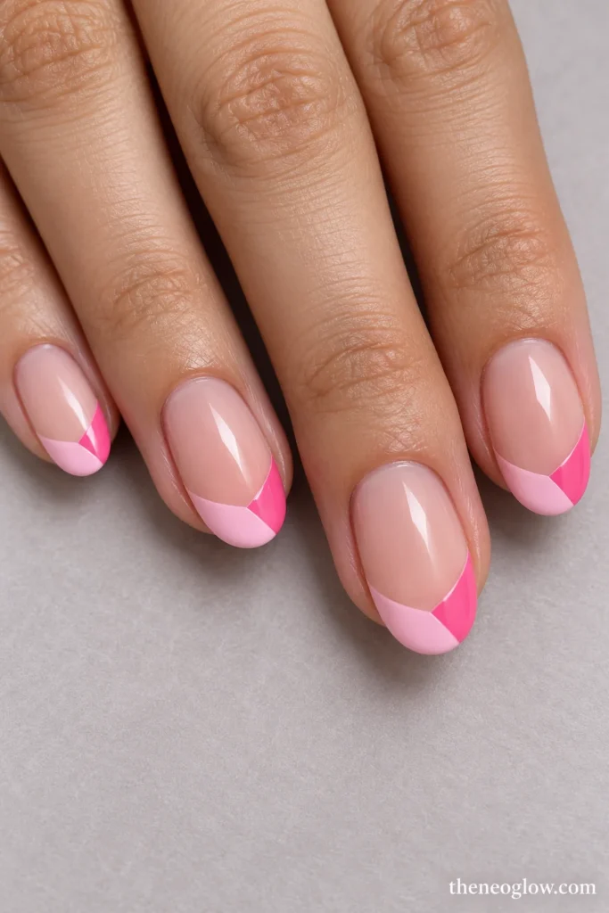 Medium oval nails with pastel and candy-pink sections divided inside glossy curved French tips.