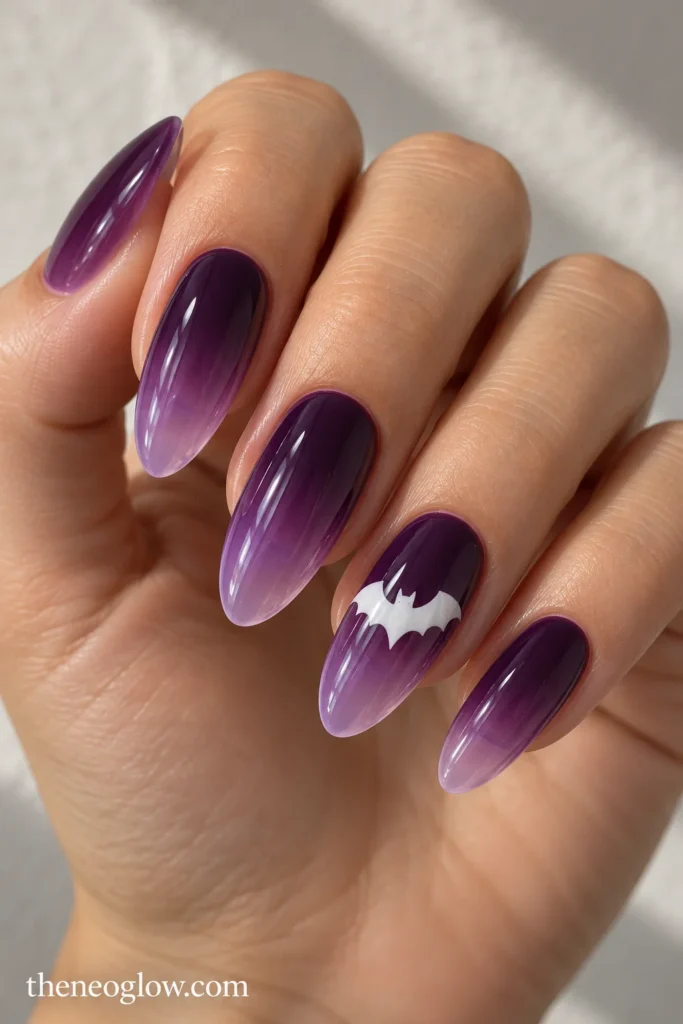 Medium almond acrylics fading from eggplant to violet, with a white bat on the ring finger.